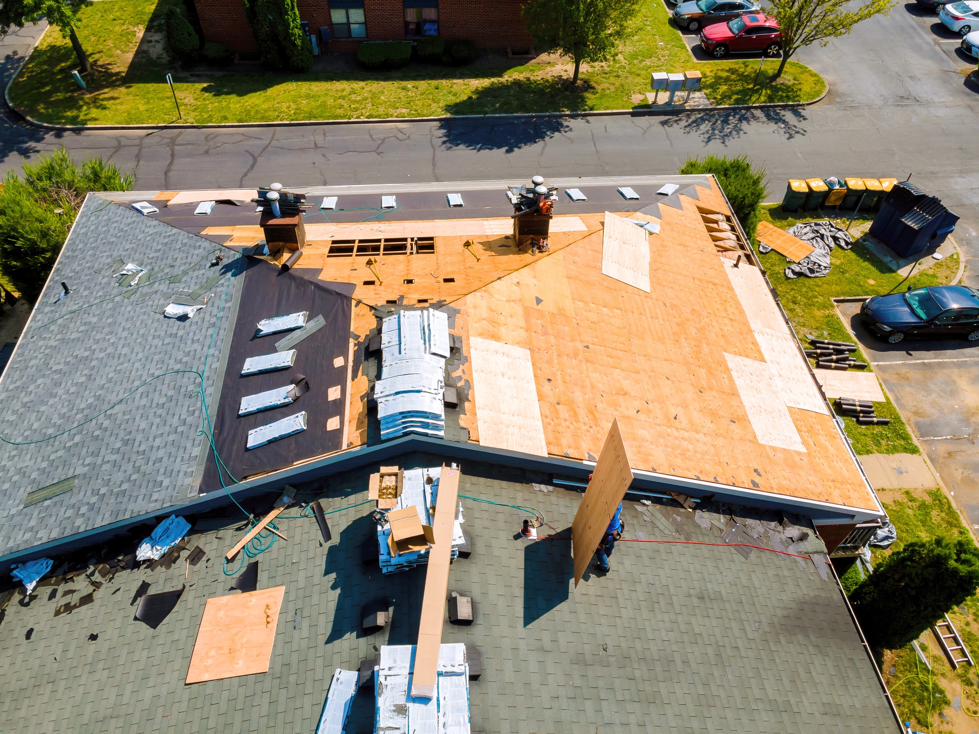 While repairing roof apartment building, old shingles replaced plywood and new shingles were