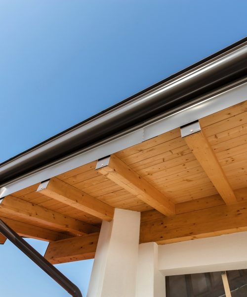 New wooden warm ecological house roof with steel gutter rain system